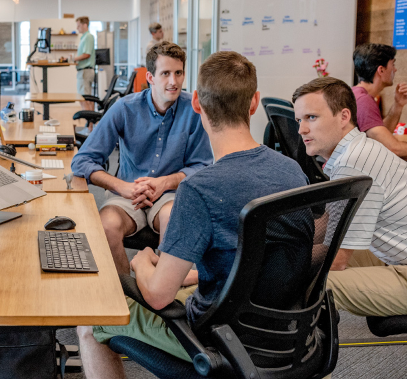 3 Men Talking to Each Other in the Office
