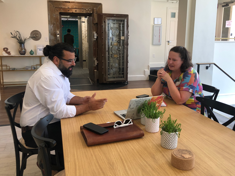 Momentum Services: two people sitting at table looking over laptop
